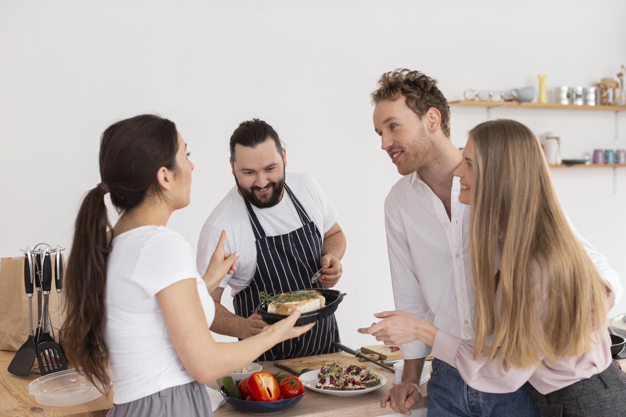 Chef explaining recipe to small group during class